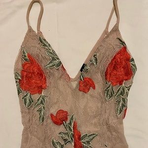 nude and floral bodysuit.
